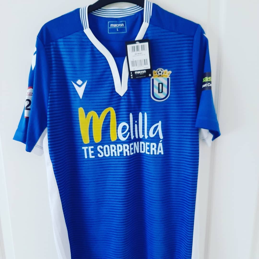 UD Melilla Home 2019/2020 Football Shirt Manufactured By Macron. The club plays football in Spain.